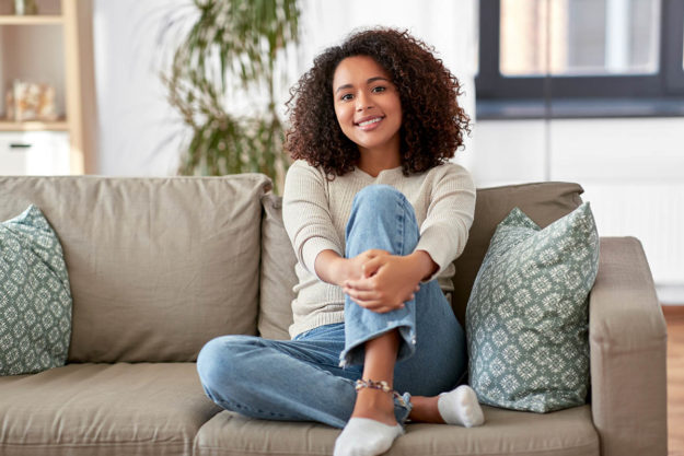 Woman enjoying sitting on the couch at a sober living home in Tampa, Florida