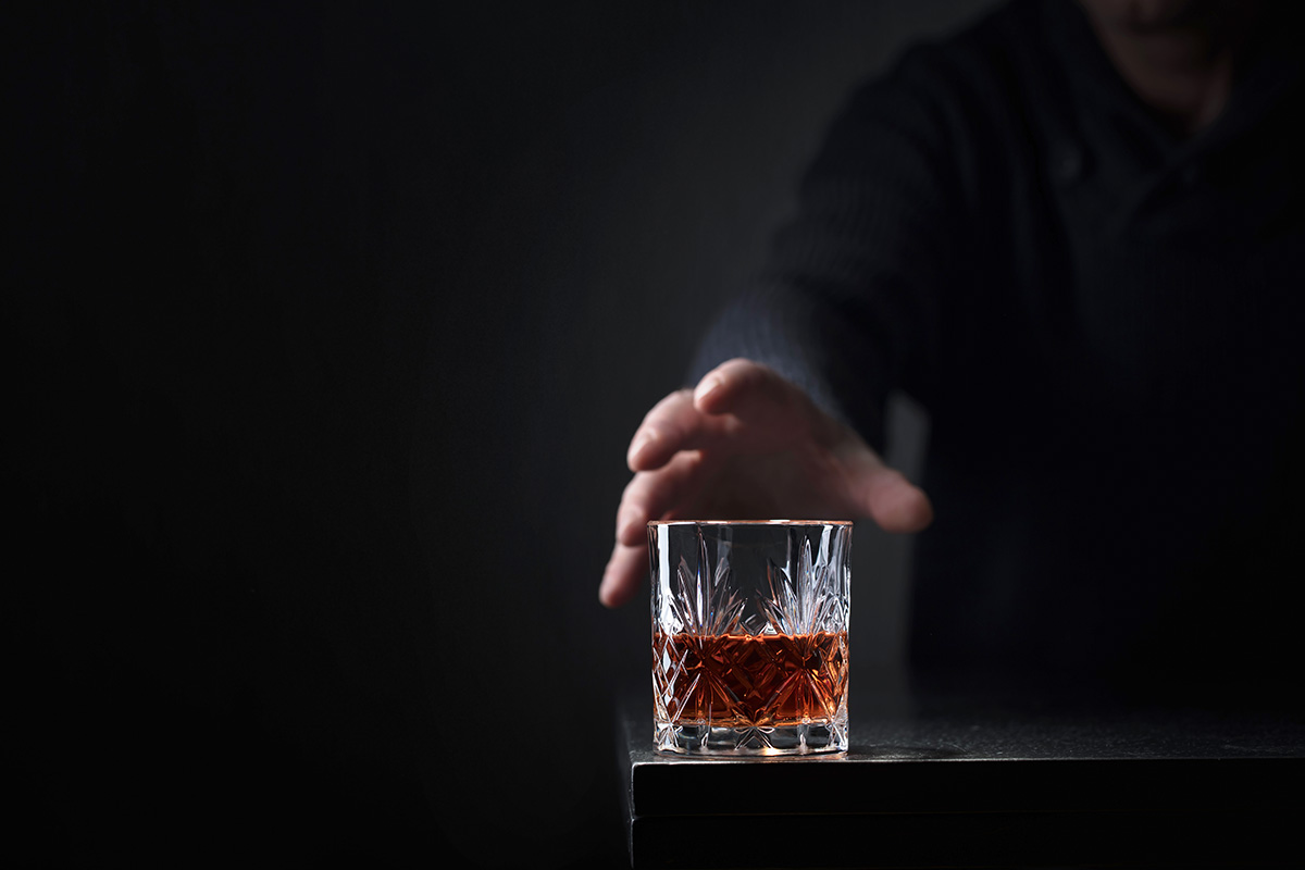 Alcohol Addiction Treatment- The Key Things to Know Man reaching out for glass of alcohol